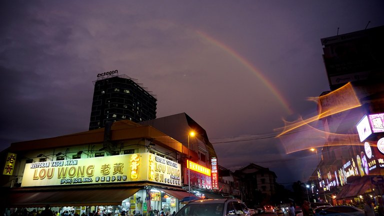 There was a double rainbow, but only one very clear and the second was kinda faded by the time I got my camera out! You can barely see it here, slightly above the clear one. A raindrop on my lens makes this unique shot! :D