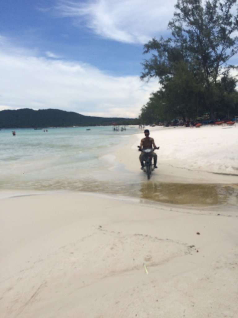 He crosses the outlet for the water system of the hotel up the beach.