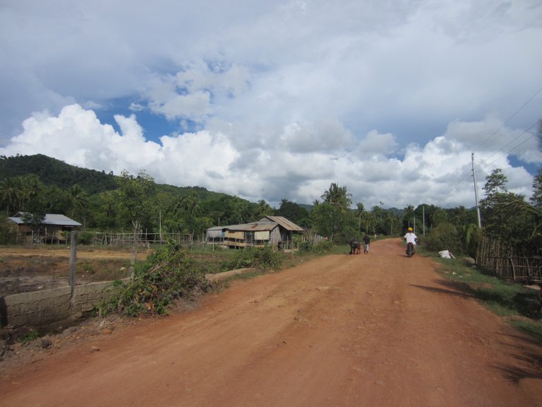 The portion of dirt road is harder to ride with two people so I take the helm and ride us through the dirt that can be quite slippery.