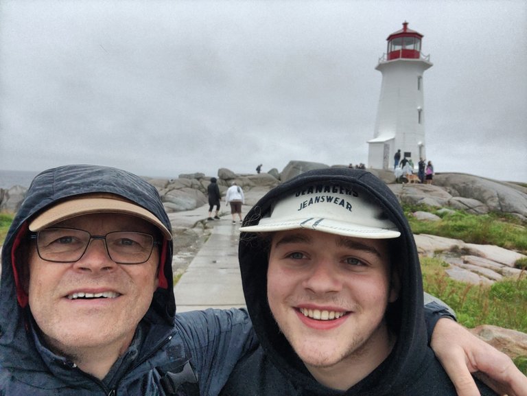 Two hearos and in the background: Peggy’s Point Lighthouse