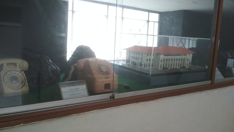 Model of the museum buildings and several old analog dial phones
