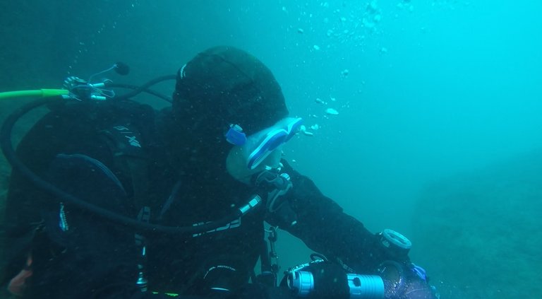 My diving partner checking depth on his computer in a shallower area.