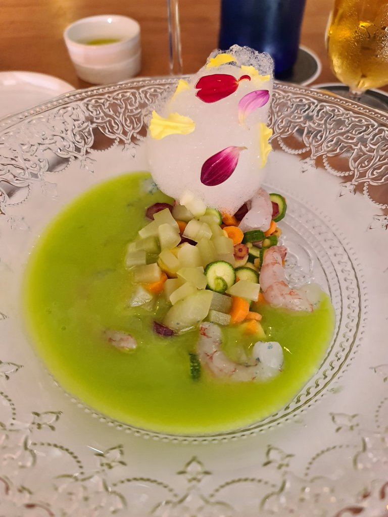 Green gazpacho with seasonal baby vegetables, raw shrimps, citrics foam and petals (€16) (2).