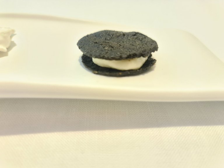 White garlic gazpacho cream and black garlic Oreo cookie (Fourth snack).