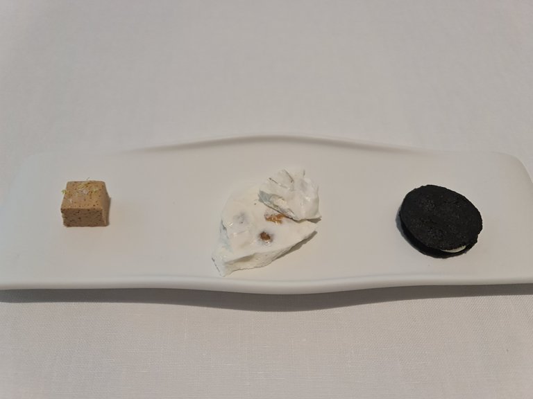 Salty almond nougats from Alicante + White garlic gazpacho cream and black garlic Oreo cookie (Second, Third and Fourth snacks).