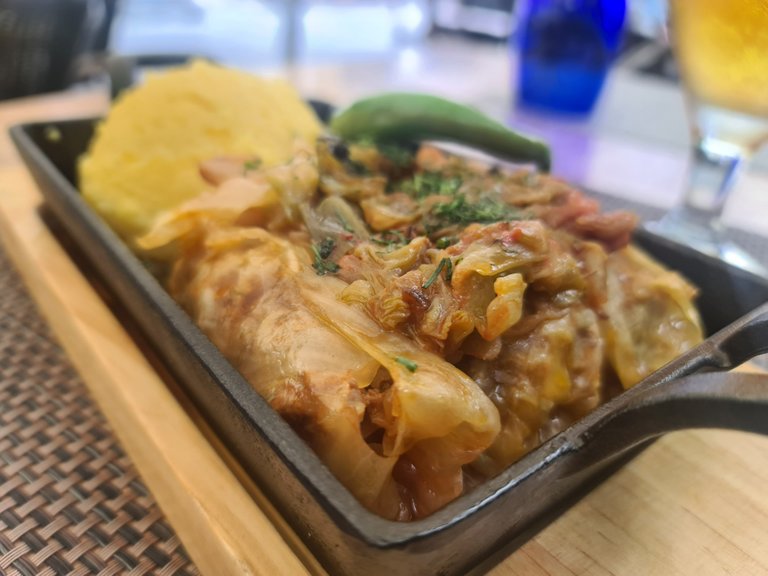”Sarmale Transilvane”: minced pork meat rolled into pickled cabbage leaves (similar to Korean ”kimchi”) topped with a kind of ratatouille and sided with a ball of polenta (cooked corn grits) and a fresh chili pepper (37 RON = 7.40 EUR) (2).