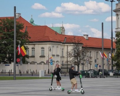 People ride through the square on a kickboard.