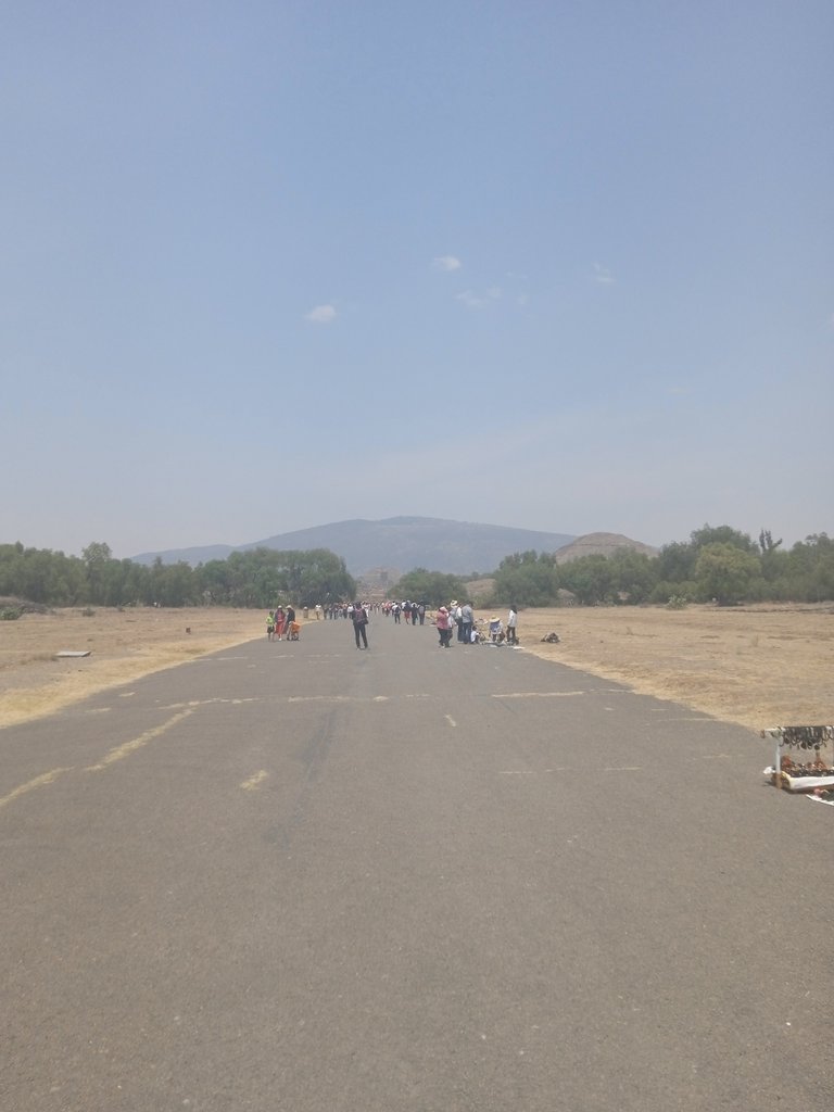 View of the Road of the dead of Teotihuacan, from the south part of the city in direction to the Moon Square. To the right you can see the top of the Pyamide of the Sun and in the back the silhouette of the Pyramide of the Moon.