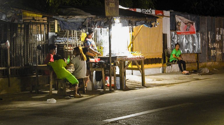 A vendor selling barbecue (skewers). I love this with good old banana ketchup!