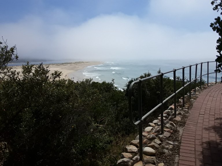 Misty curtains rolling back on Lookout beach as the sun rises higher