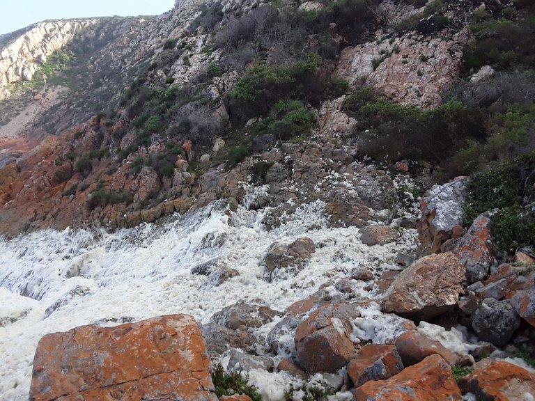 Rough seas washing up to the cliff edge