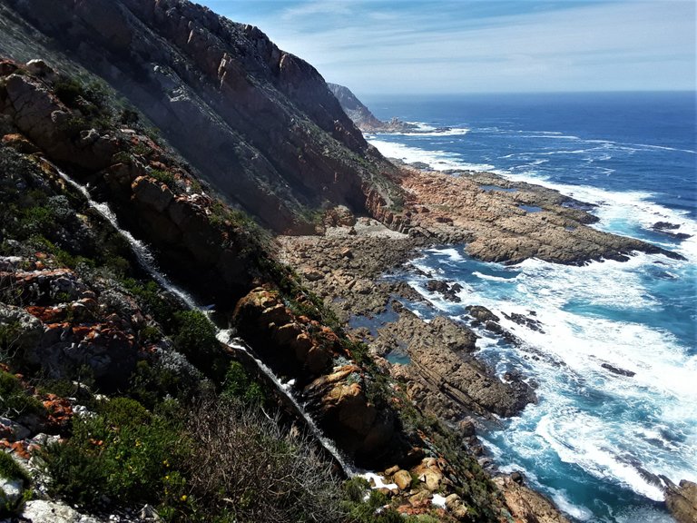 A wider landscape view of the local rain water as it falls to the shoreline