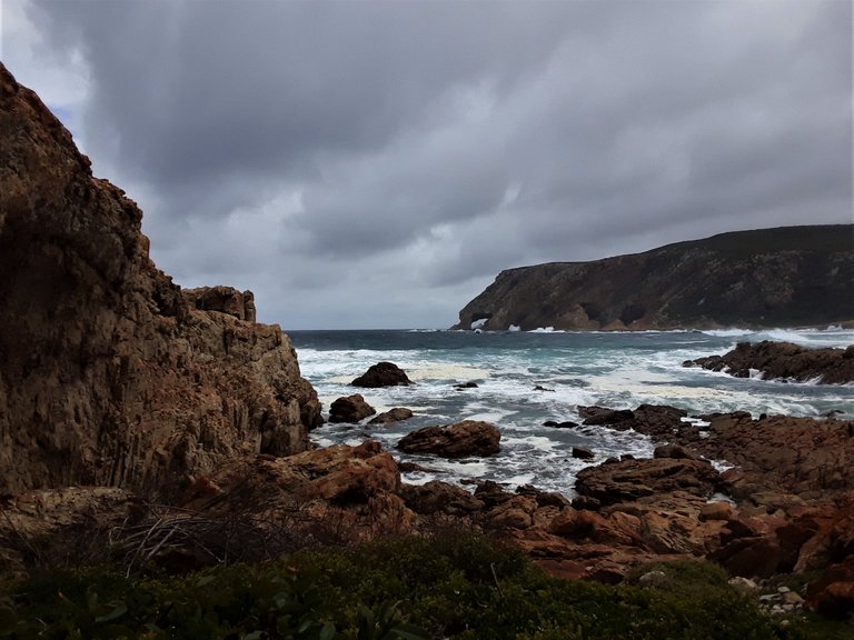 A moody moment under looming cloud and rocks