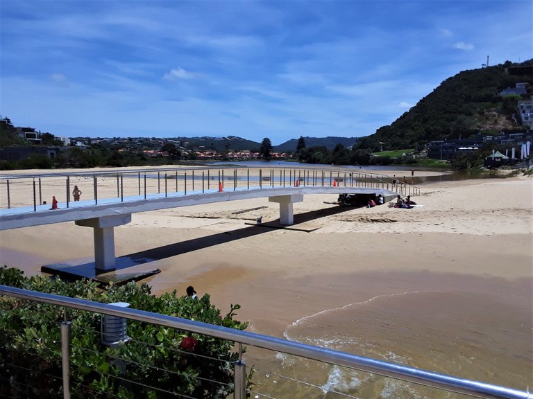 The Piesang (Banana) River trickles down the valley and under this pedestrian bridge to flow into the sea