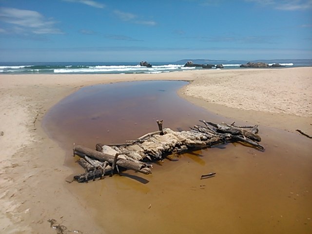 The same bridge from the other angle, crossing the little stream that flows to the sea