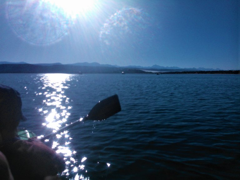Dazzling sunshine reflecting on the water with the Tsitsikama mountain range in the distance