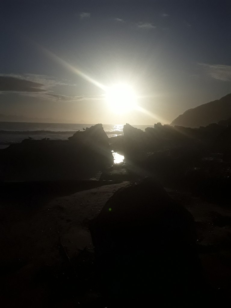 Sunrise on the equinox aligning with the rocky channel at Robberg peninsula