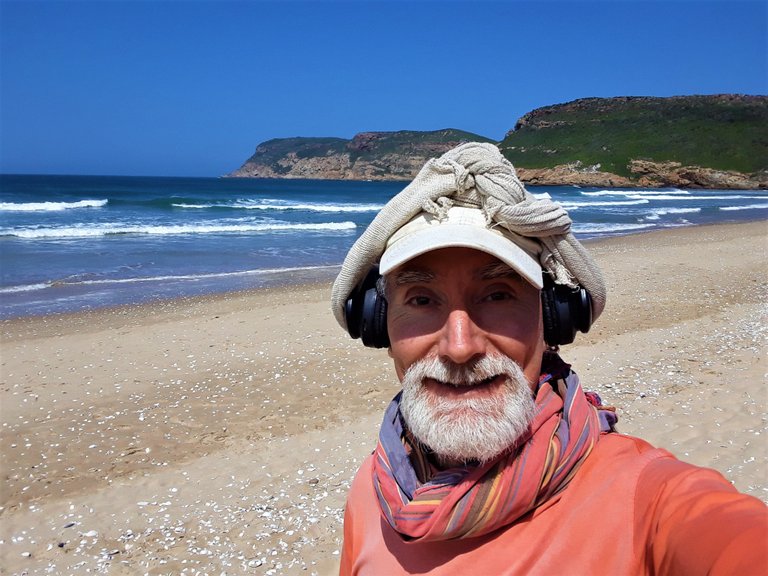 Portrait of the author as a happy camper on Robberg beach, peninsula in the background.