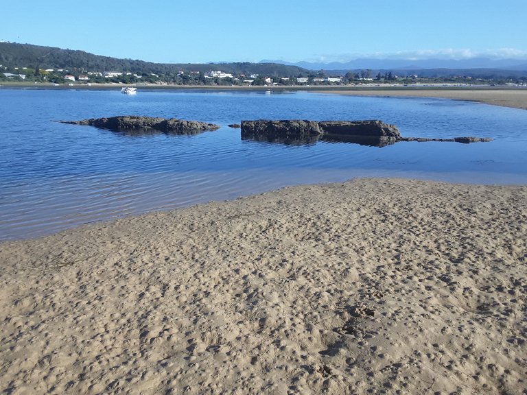 You can see all the holes in the sand, in which the shrimp and other sea creatures hide - now exposed at low tide