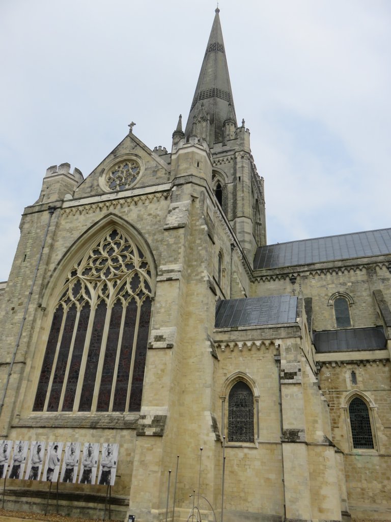 The outside of the cathedral from the cloisters with some more tat plastered on the walls.