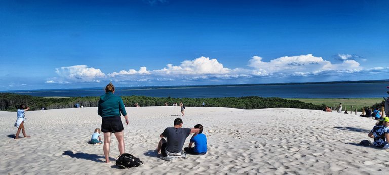 A bunch of people are on the dunes