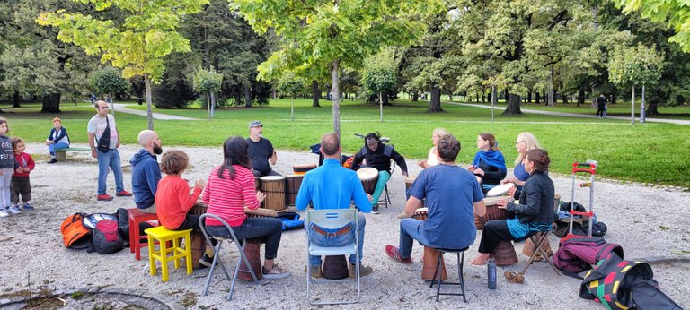 The are drumming for fun in a city park