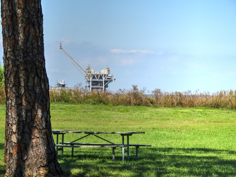 Near the shoreline are a few of oil rigs