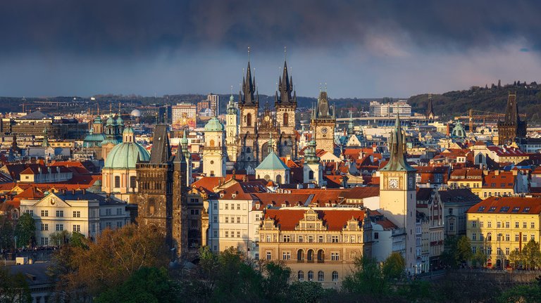 Golden light illuminates the Prague skyline.