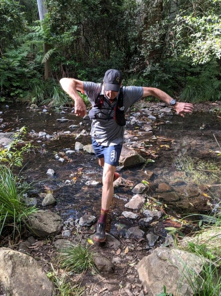 Me, caught mid step, crossing that same creek. (Thanks for the photo Conscious Cat)