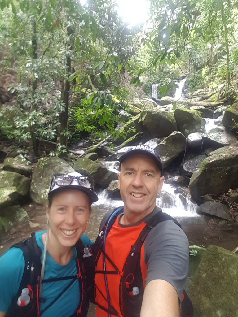 Us! At the waterfall. The hike was long enough (and the weather hot enough) that we took our water bladder packs so we both had sufficient water for the whole morning.