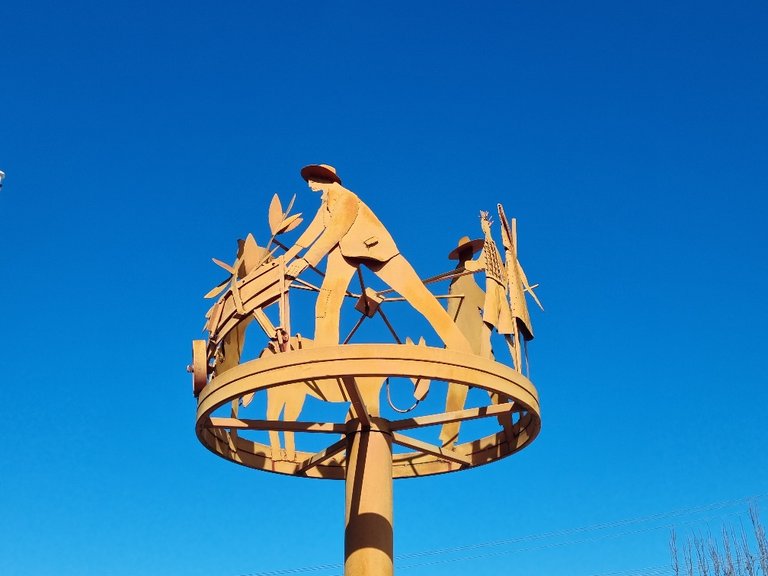 A steel sculpture depicting local farming practices.