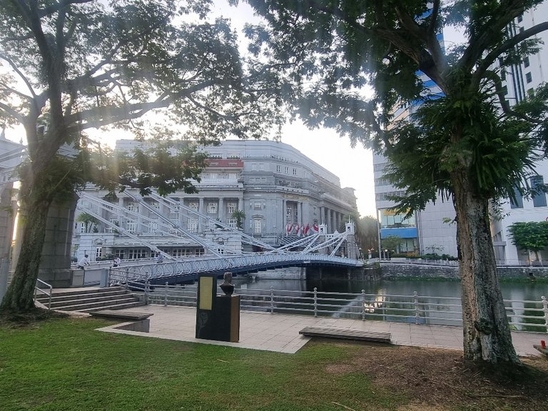 The white Anderson Bridge in front of the Fullerton Hotel.