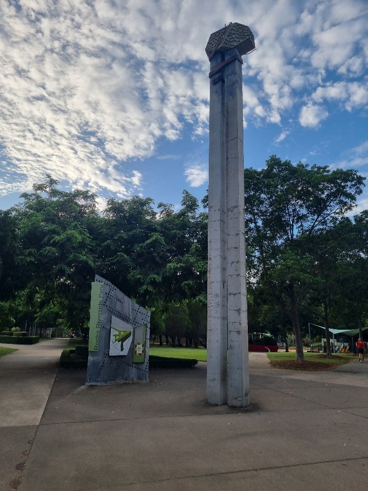 A conveyer belt pylon standing tall at the parks entrance.