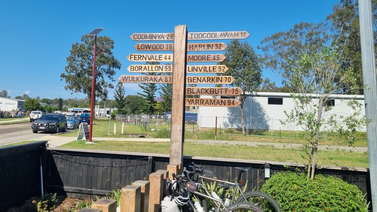 A rail trail sign post and a couple of gravel bikes.