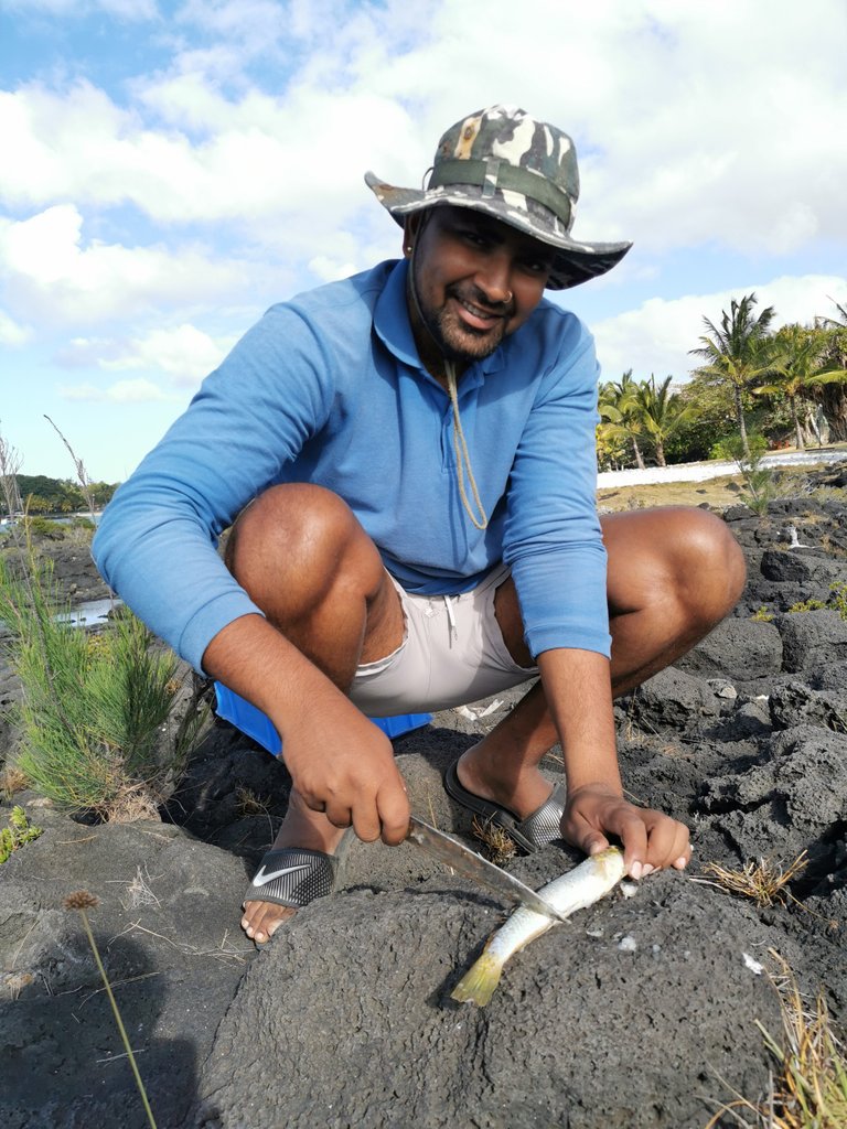 Karan cleaning the first catch and cut as bait...