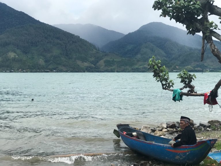 An Old Man Inside a Canoe