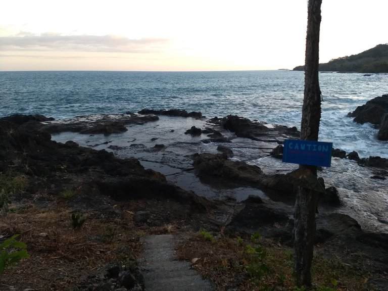 Large tide pool distant in center.