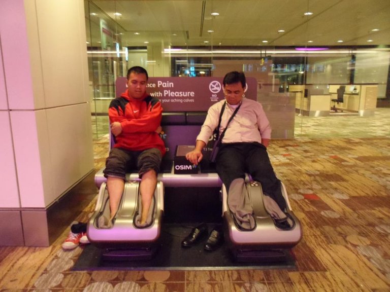 My dad (right) and I trying the airport’s free foot massage chair