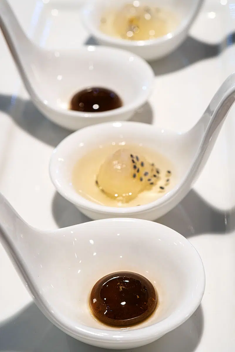 A drop of Vietnamese coffee with condensed milk in the middle and longan compote with lotus.