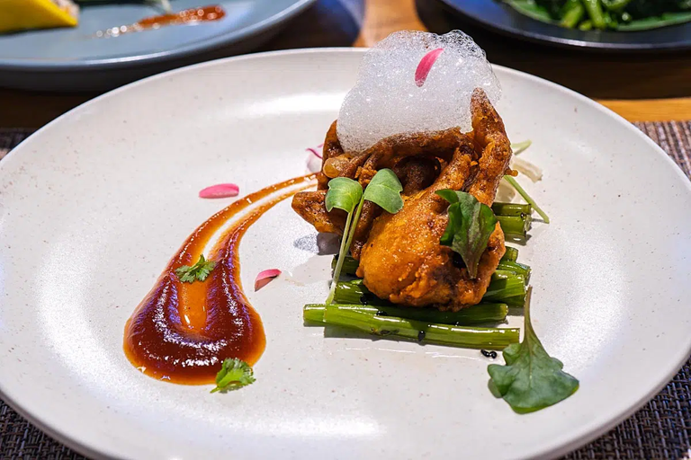 Soft-shelled crab with tamarind sauce, apple foam, and greens.