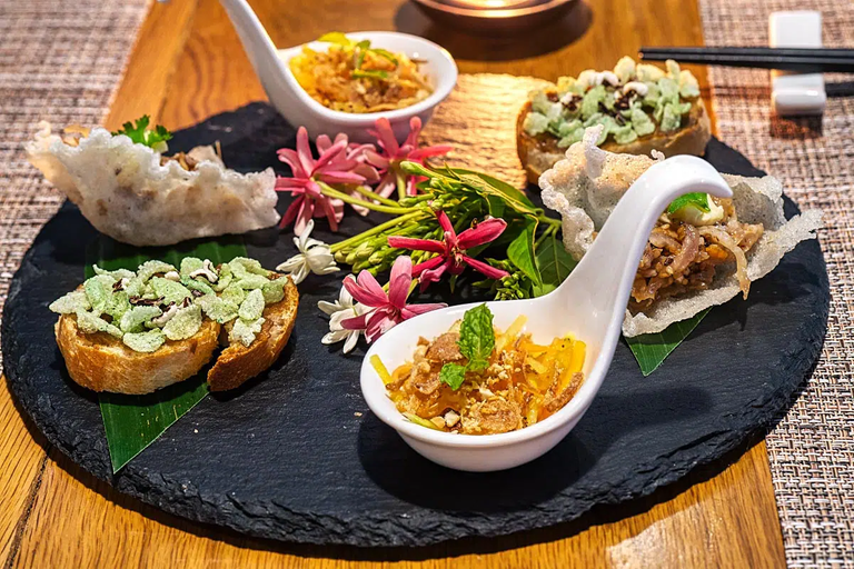 Amuse-bouche: Eggplant spread on toasted bread, Fermented pork with pig ears on crisp base, Jelly-fish salad with caramelized vegetables and peanuts