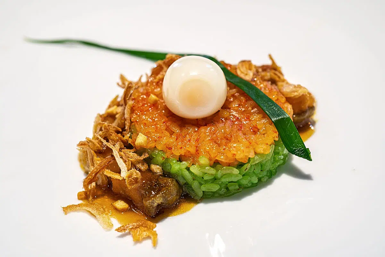 Gac and pandan Sticky rice, smoked fish, pepper sauce and still runny quail egg.