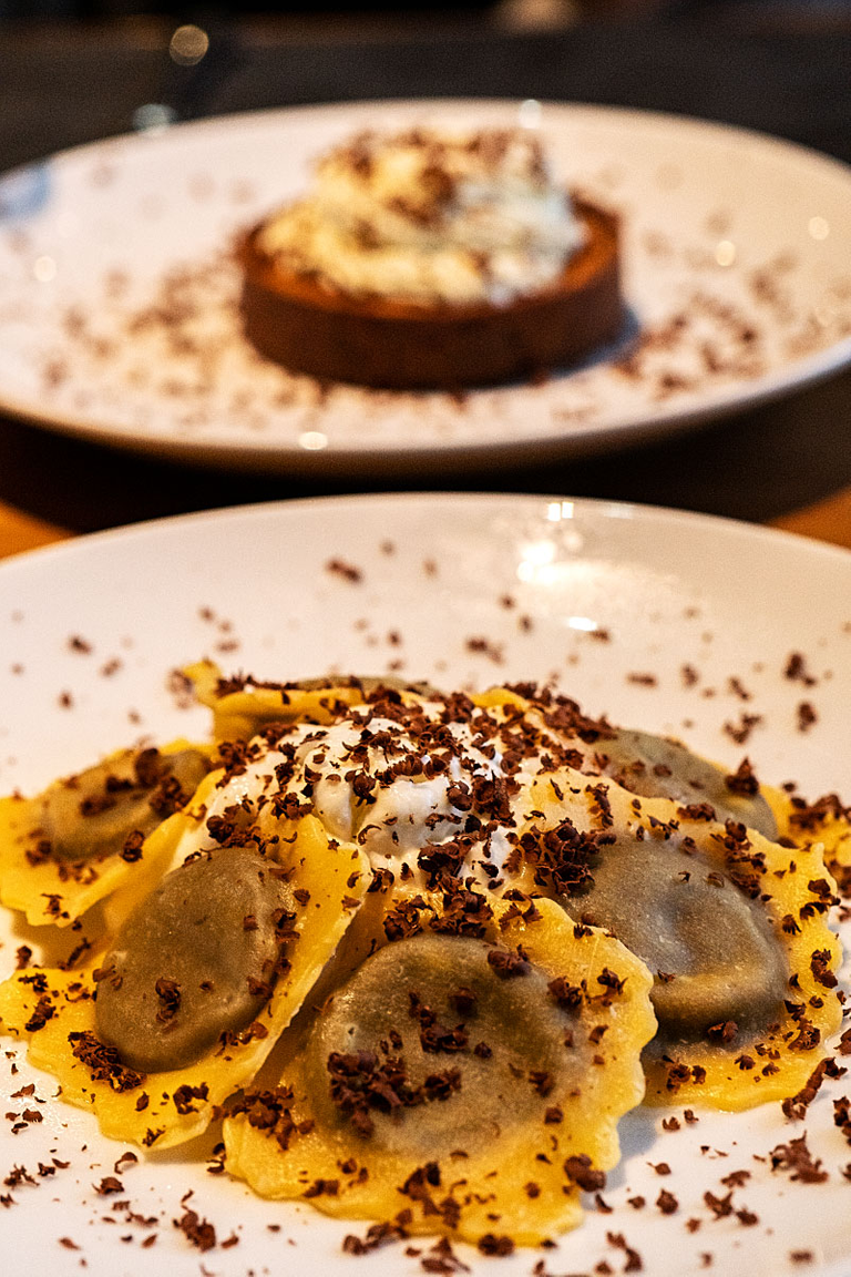 Ricotta chocolate ravioli circled around the light lime cream.