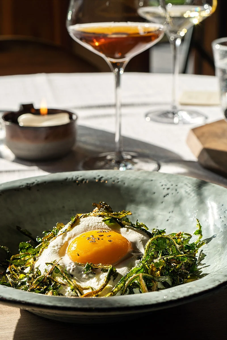 Confit egg yolk on yogurt cream with fried dandelion and buckwheat