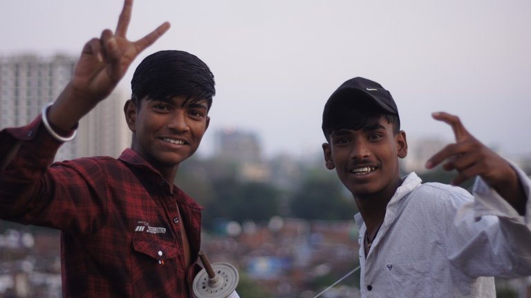 Two boys flying a kite. Sakha Atawati, Babu