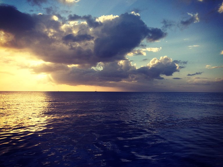 A sailboat heading out into the night. Wallilabou Bay, SVG, Eastern Caribbean 