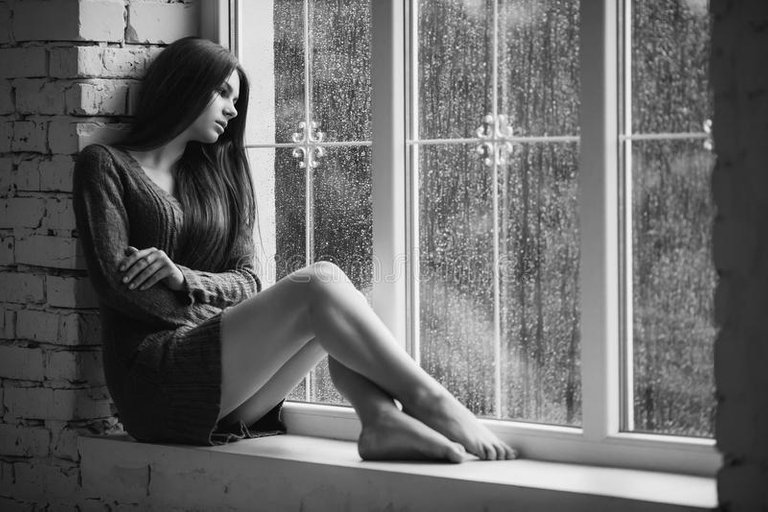 xbeautiful-young-woman-sitting-alone-close-to-window-rain-drops-sexy-sad-girl-concept-loneliness-black-near-long-slim-66485280.jpg.pagespeed.ic.UCuPHXufbx.jpg