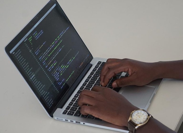 man coding at computer with watch.jpeg