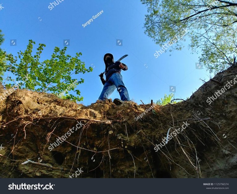 stock-photo-with-a-machete-in-hands-1125796574.jpg