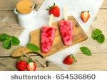 stock-photo-fresh-homemade-strawberry-ice-cream-on-wooden-background-organic-and-vegan-popsicles-654536860.jpg